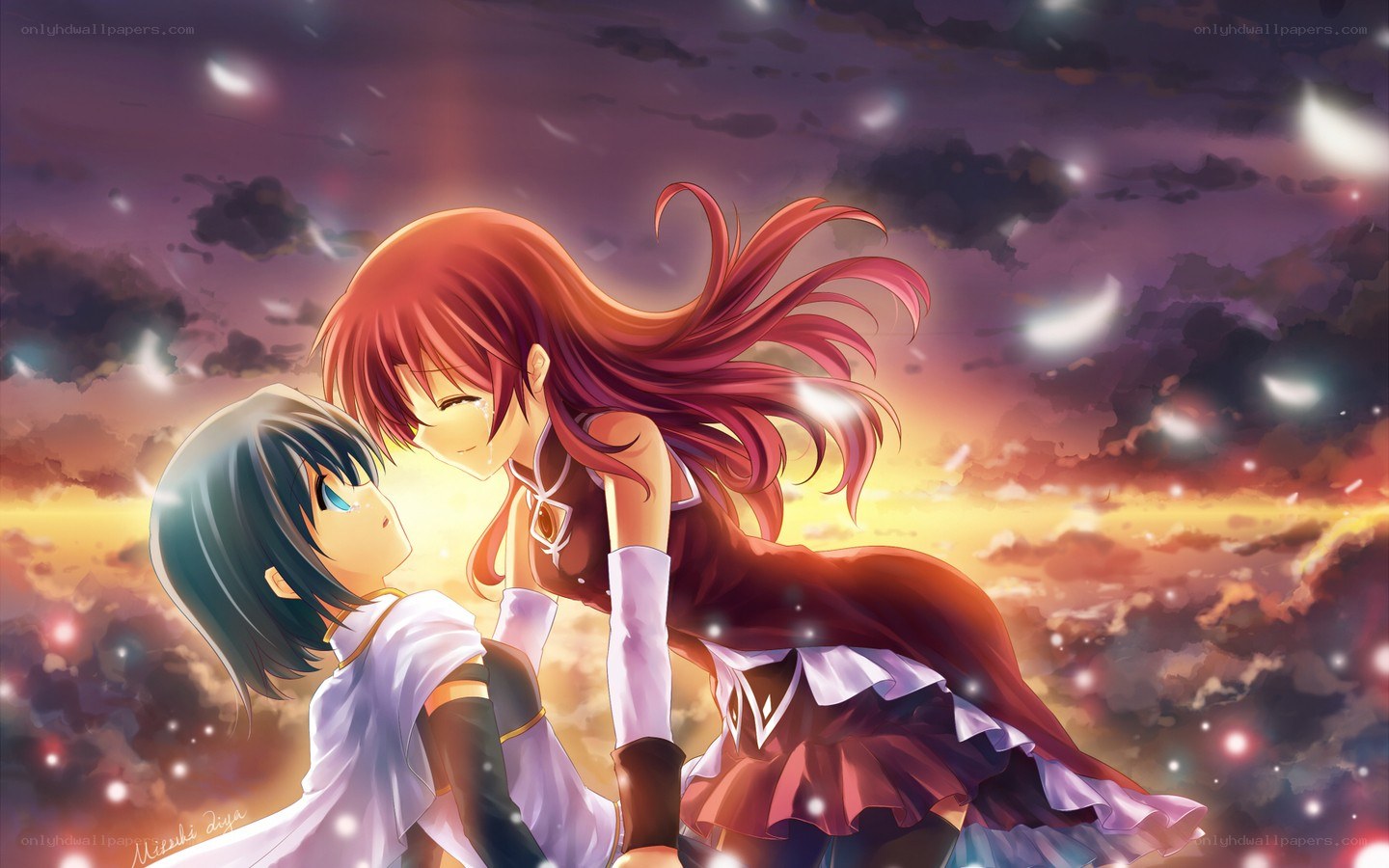 Two girls embracing at sunset