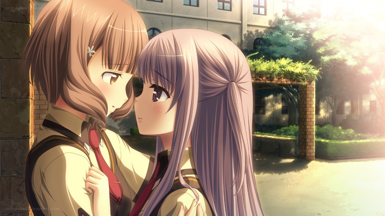 Two girls embracing in sunlight