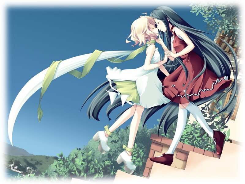 Two girls embracing on a hill