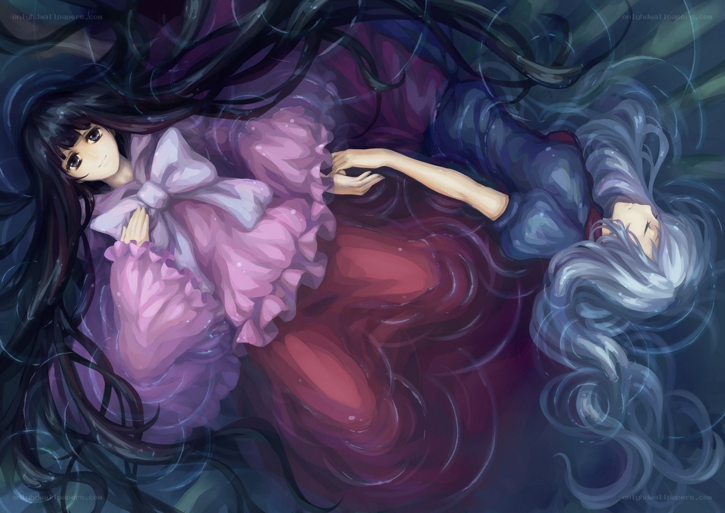 Two girls floating in water