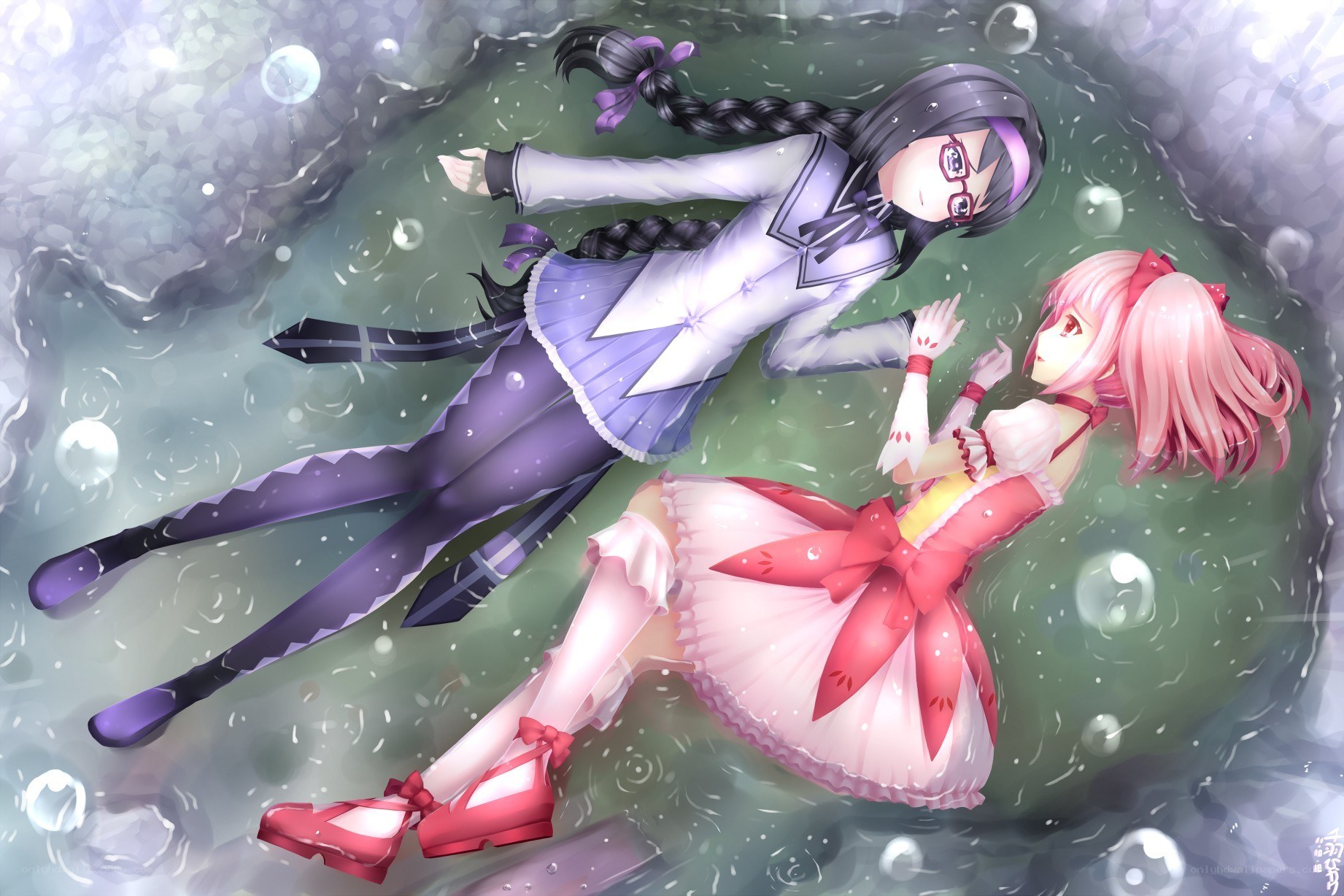 Two girls floating underwater