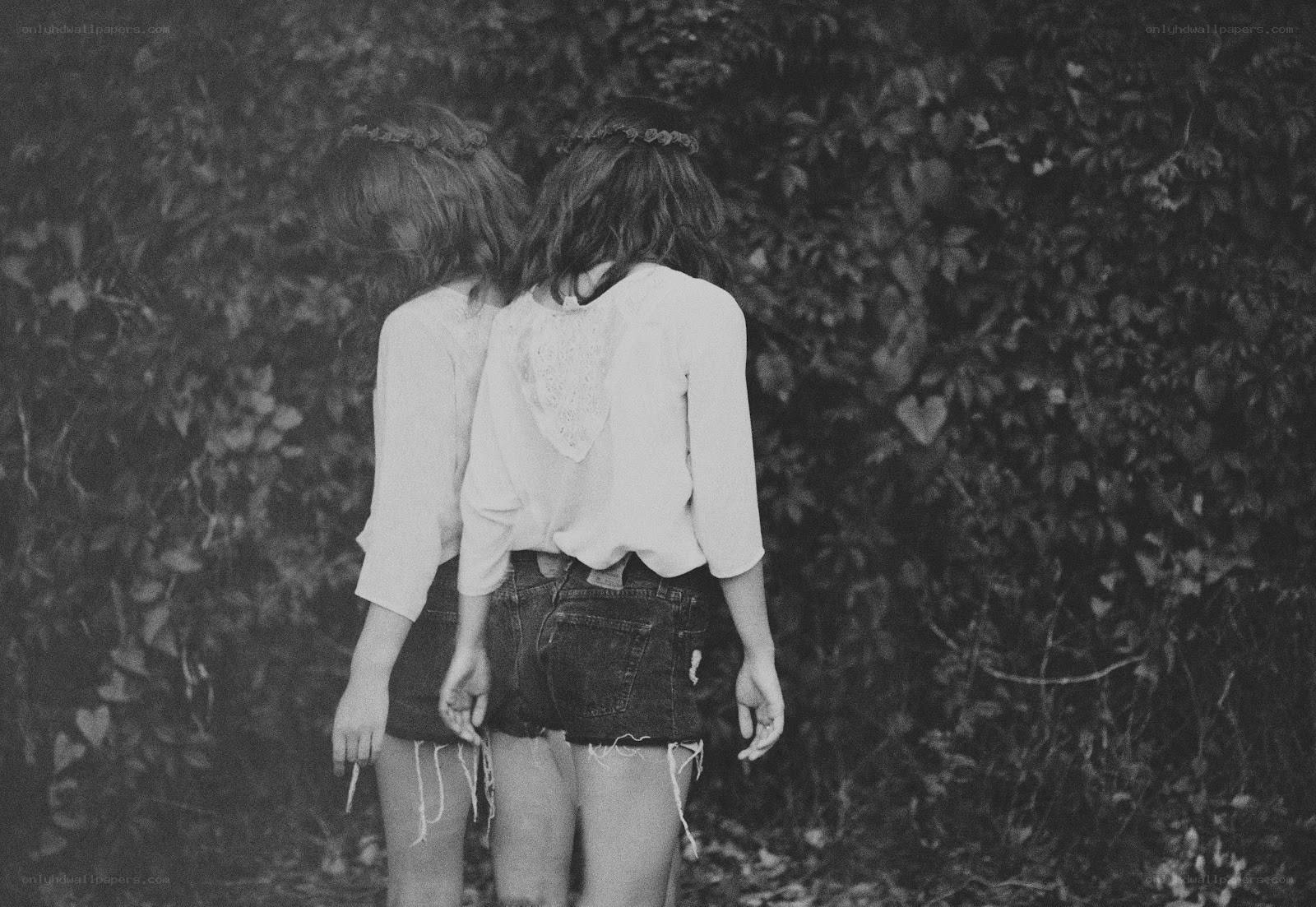 Two girls from behind in nature