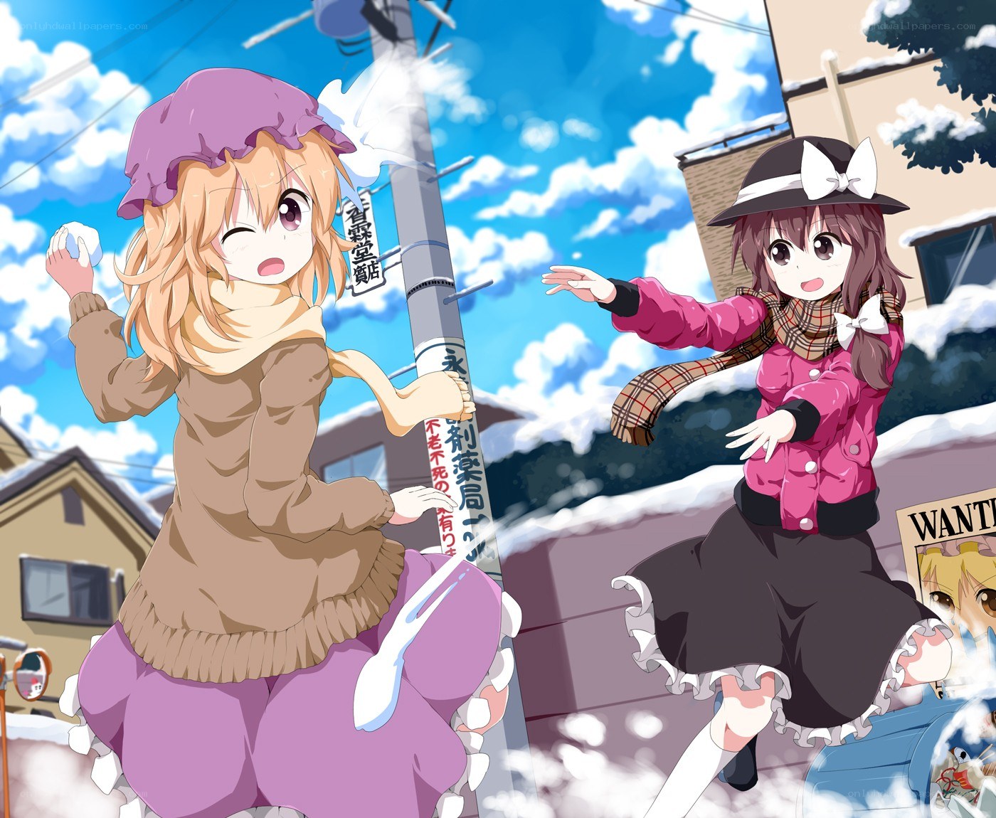 Two girls having a snowball fight