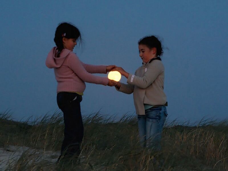 Two Girls Holding a Light