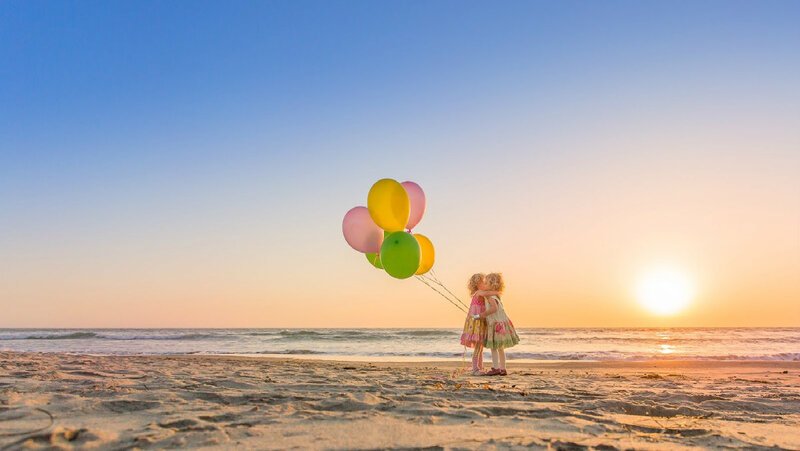 Two Girls Holding Balloons