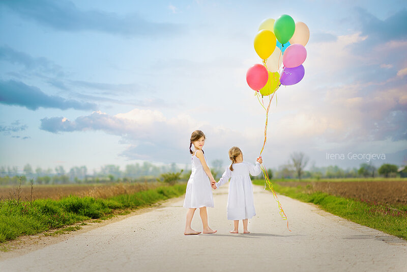 Two Girls Holding Balloons — White
