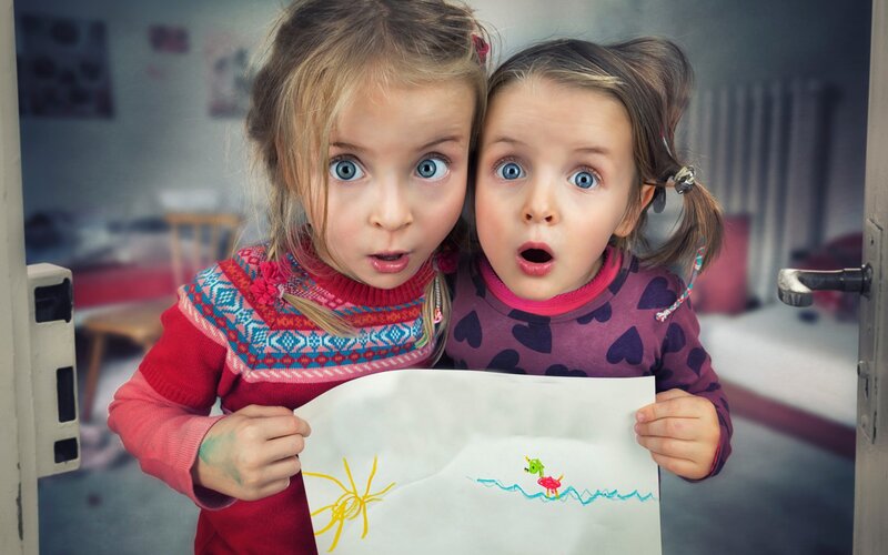 Two Girls Holding Drawing