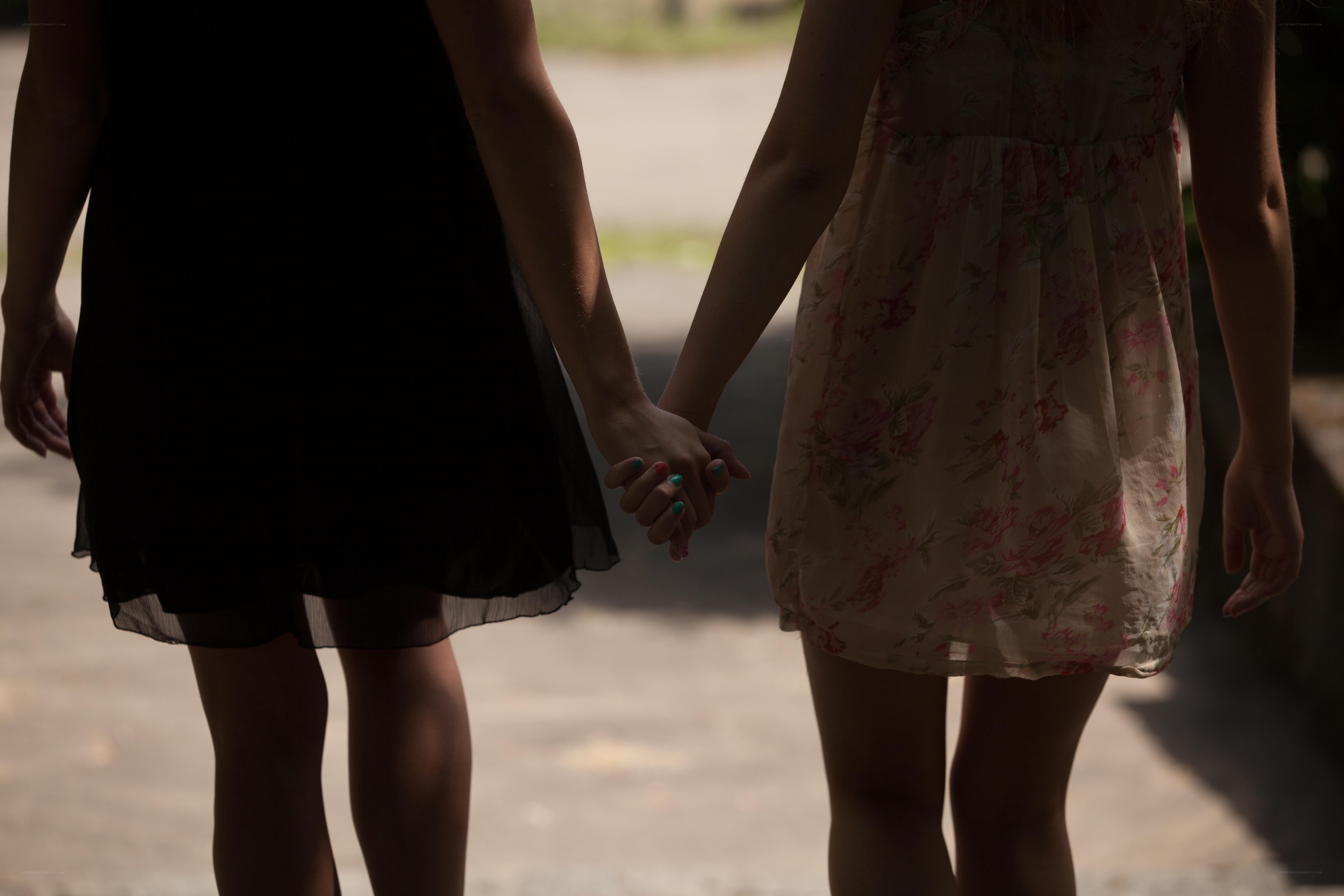 two girls holding hands