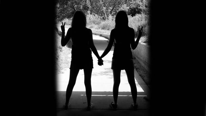 Two Girls Holding Hands — Black