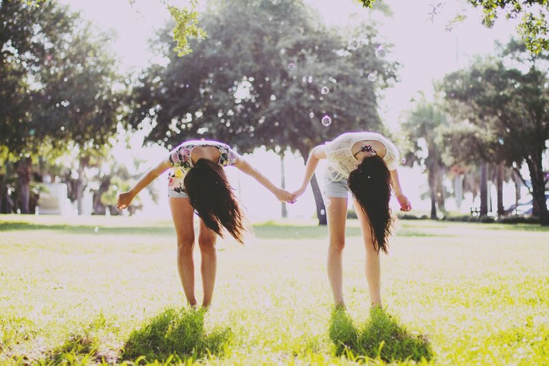 Two girls holding hands in a park