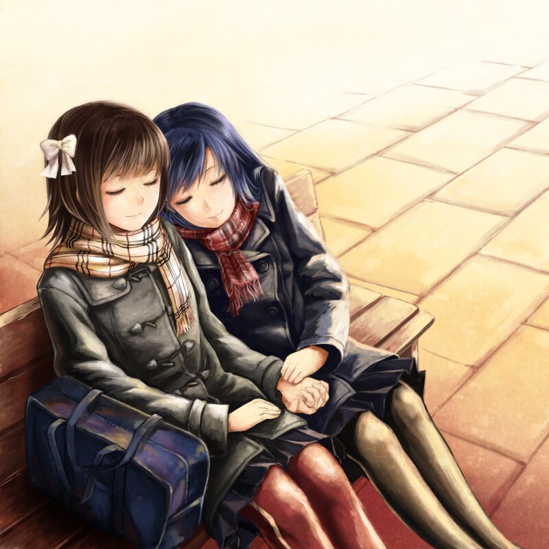 Two girls holding hands on a bench
