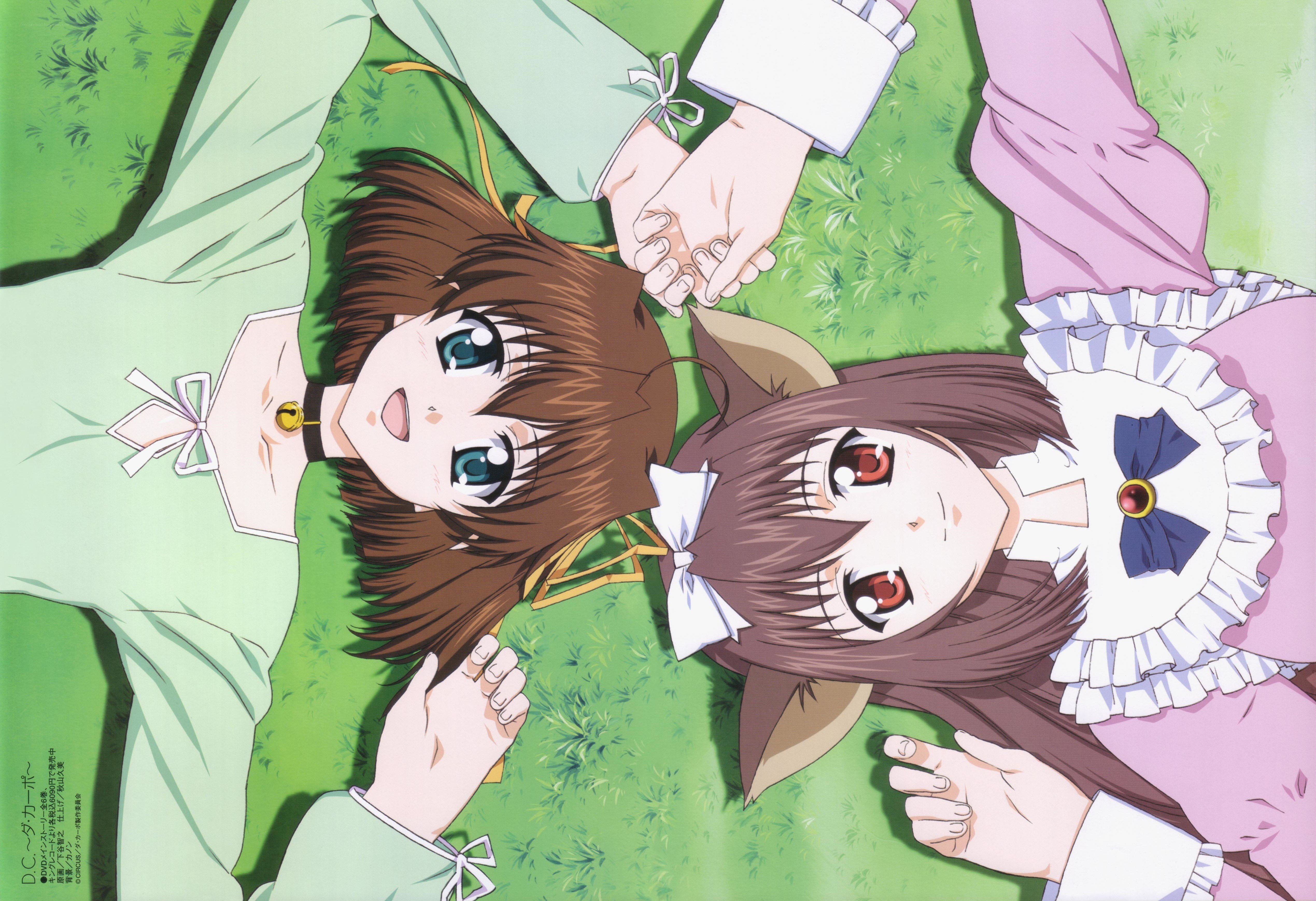 two girls holding hands on grass