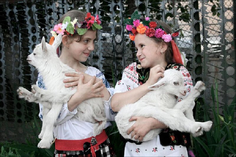 Two Girls Holding Lambs