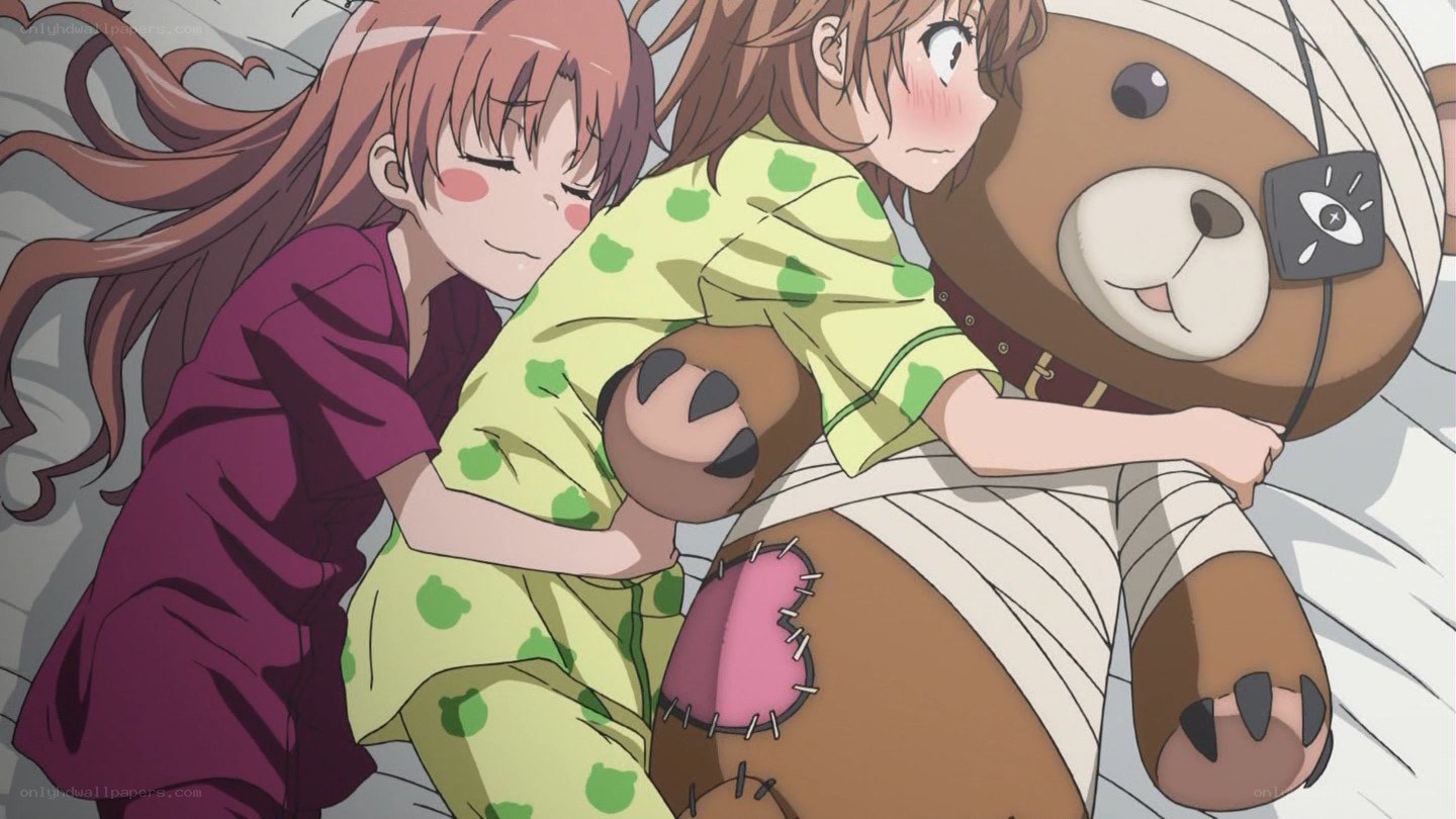 Two girls hugging a teddy bear