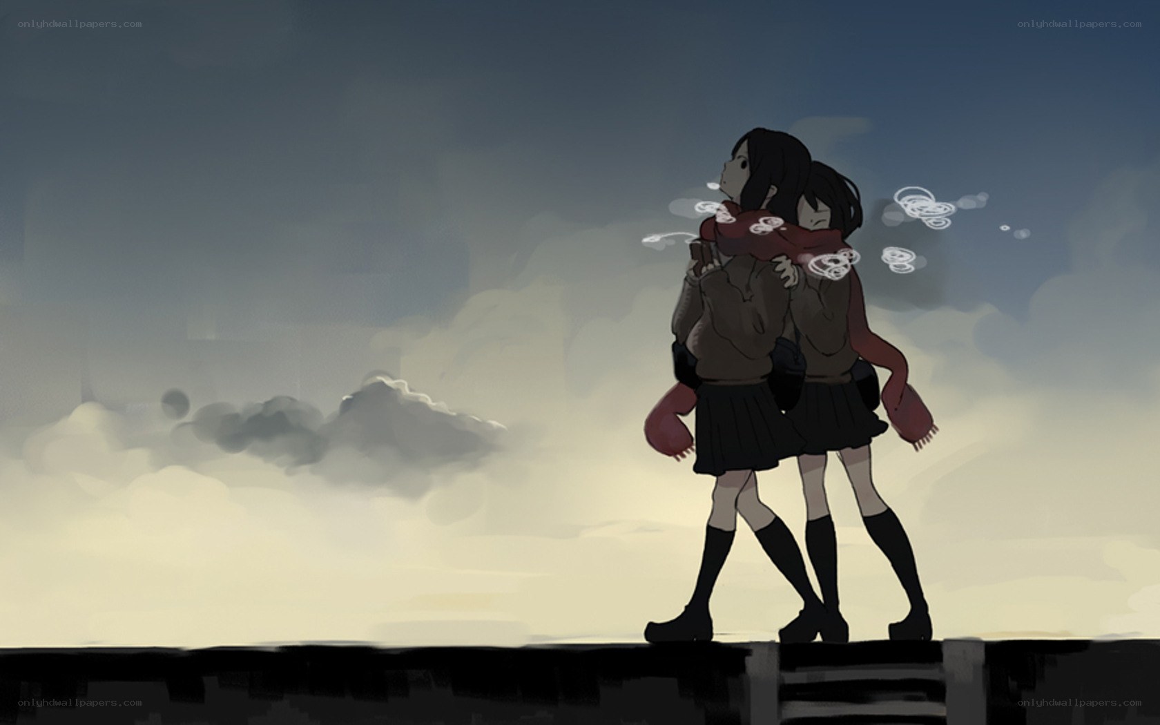 two girls hugging at sunset