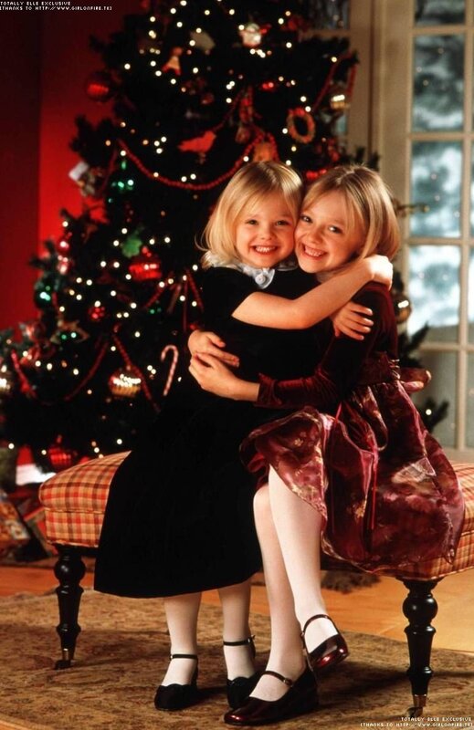 two girls hugging by christmas tree