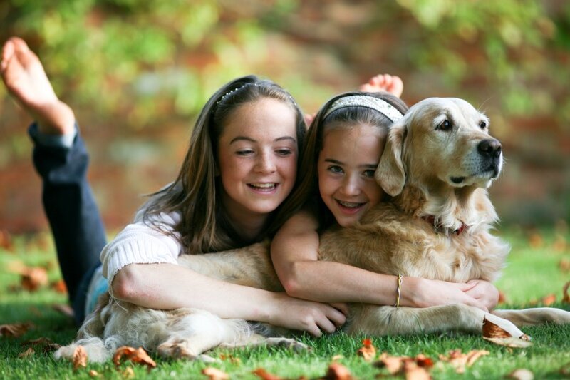 Two Girls Hugging Dog