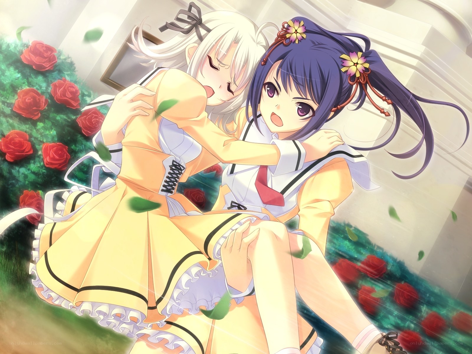 Two girls hugging in a garden