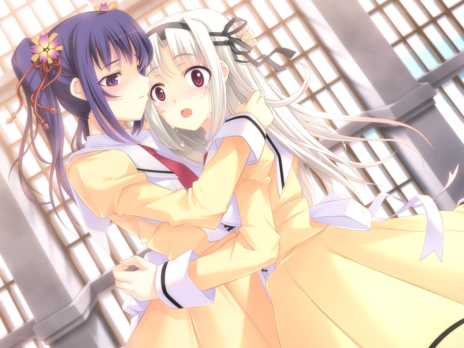 Two girls hugging in a school