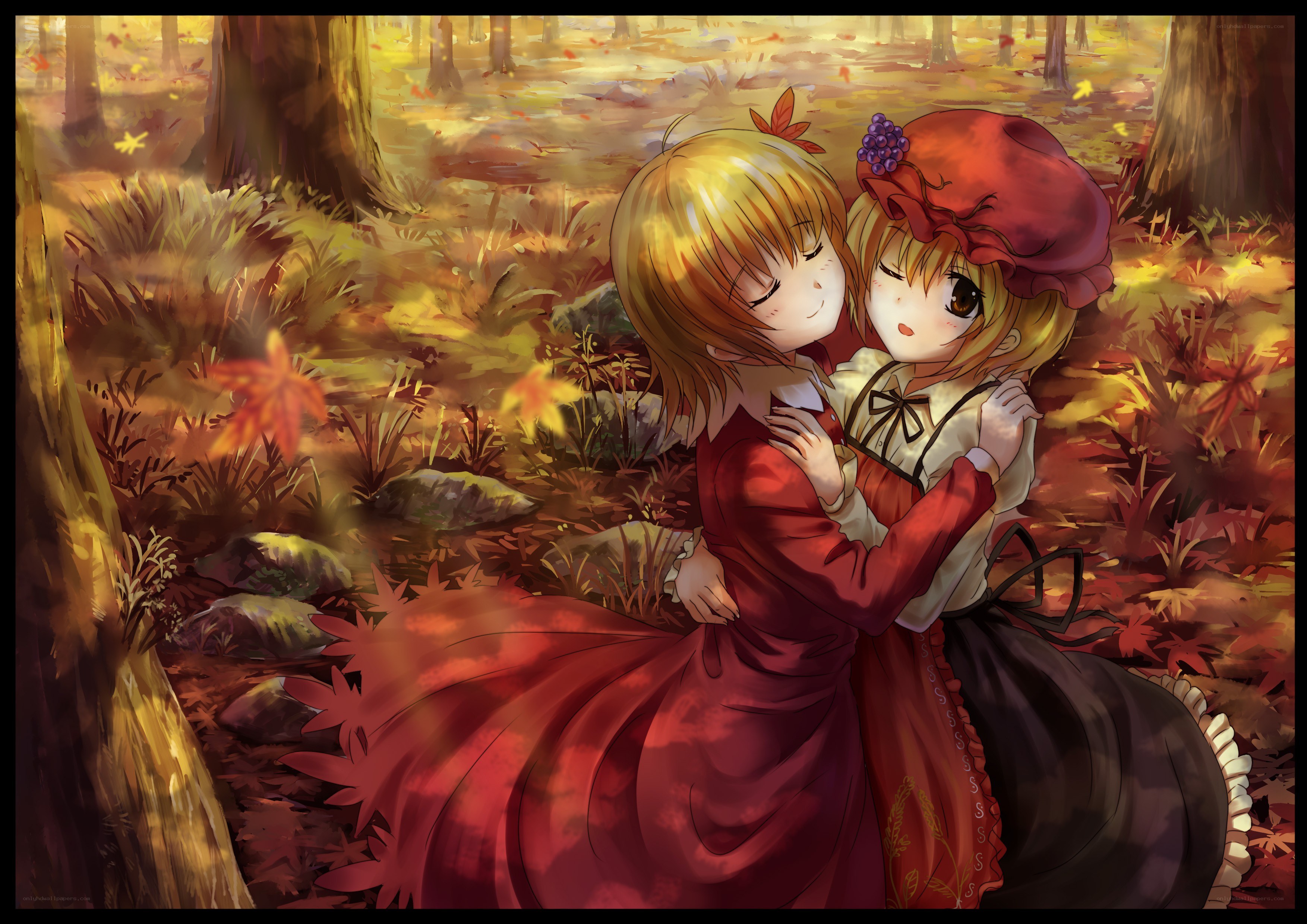 Two girls hugging in autumn