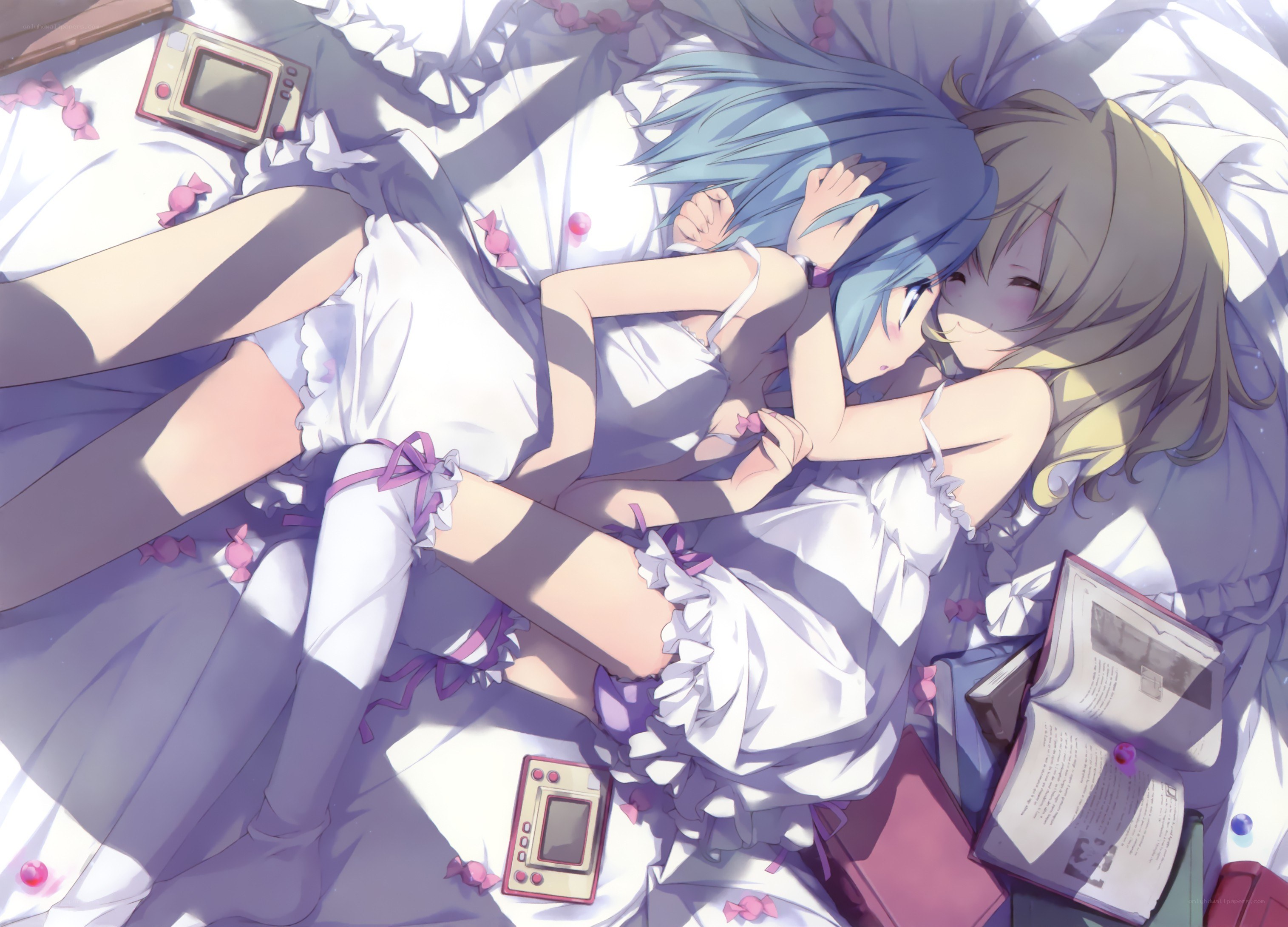 Two girls hugging in bed