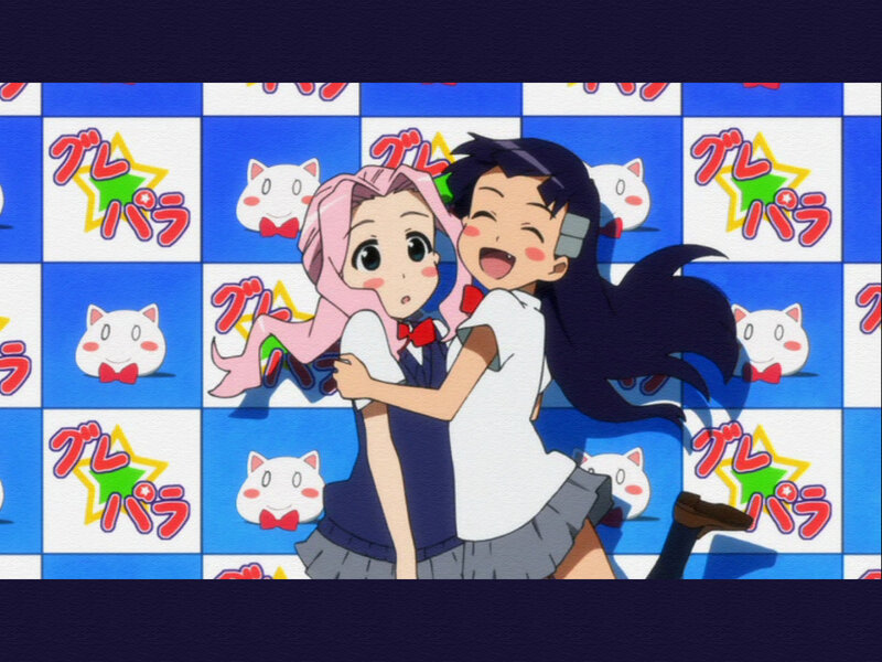 Two girls hugging in front of a patterned wall