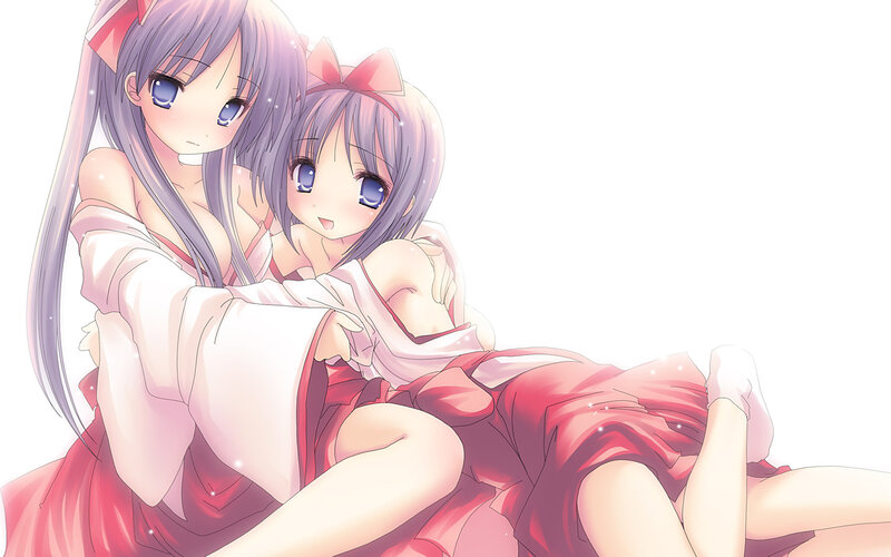 two girls hugging in red dresses