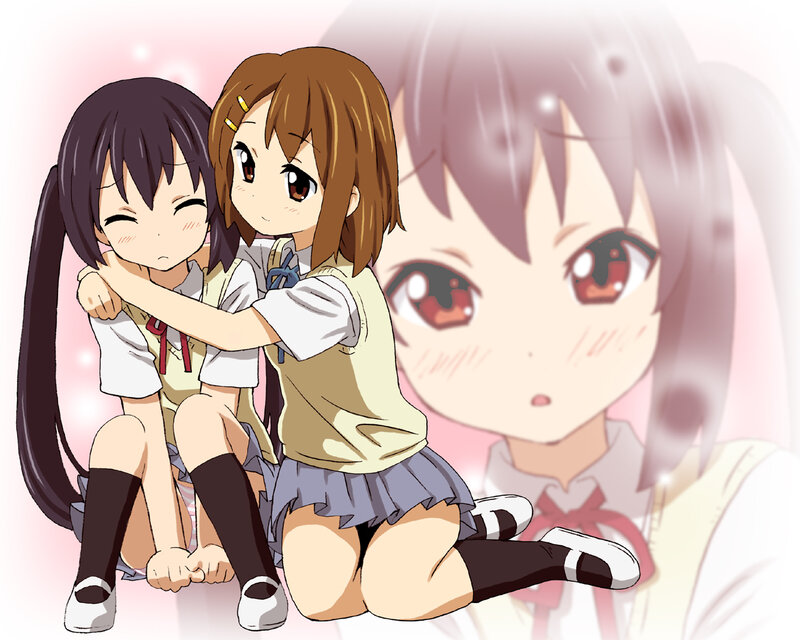 Two girls hugging in school uniforms