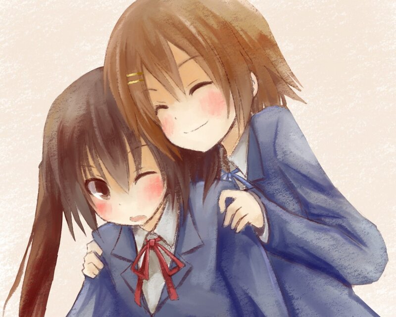 Two girls hugging in school uniforms