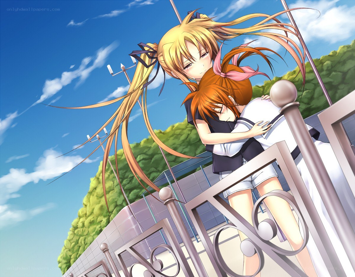 Two girls hugging on a balcony