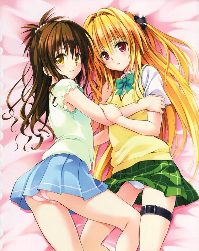 Two girls hugging on a bed