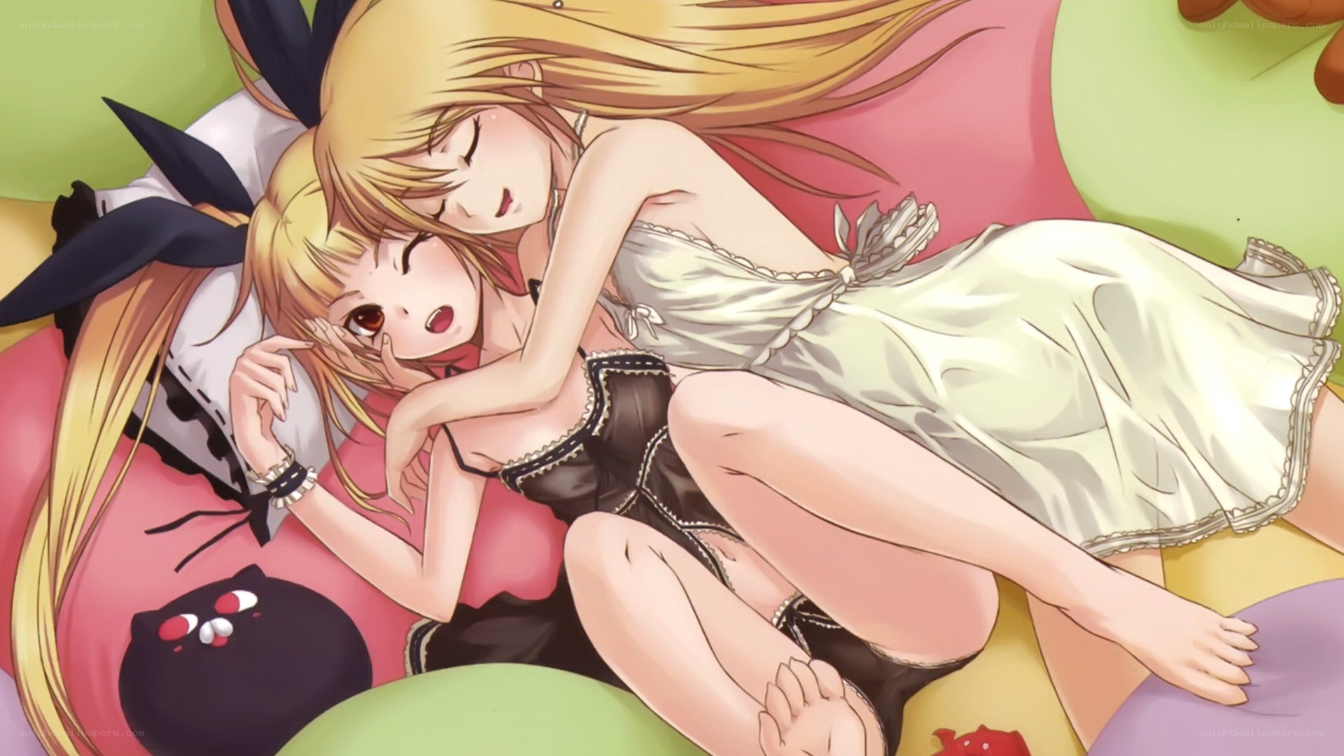 Two girls hugging on a bed