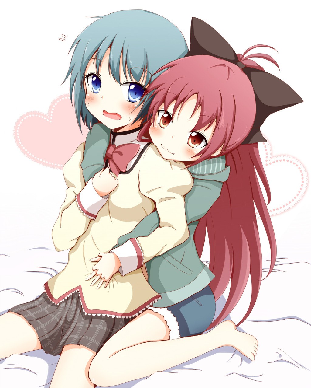 Two girls hugging on a bed