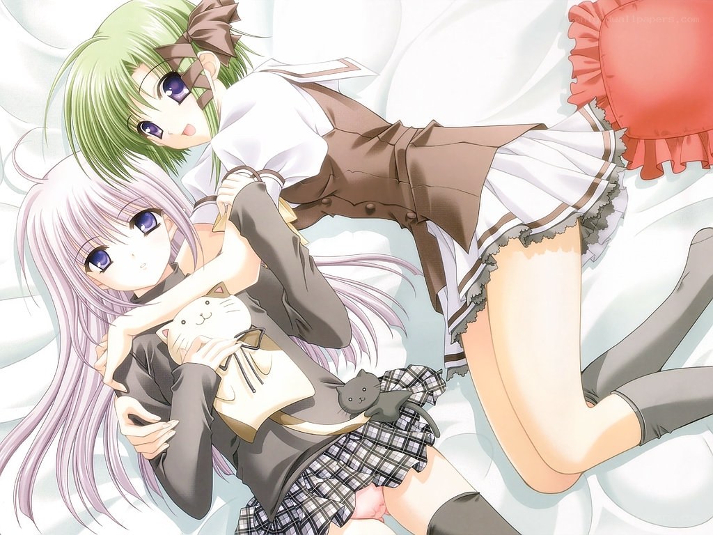 Two girls hugging on a bed