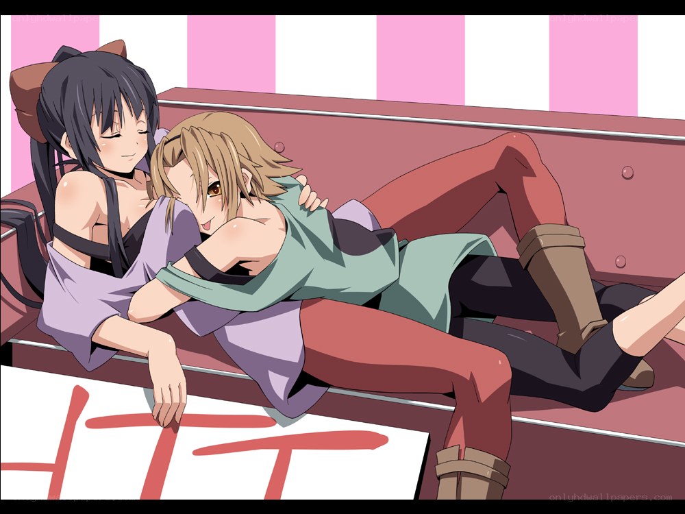 Two girls hugging on a bench