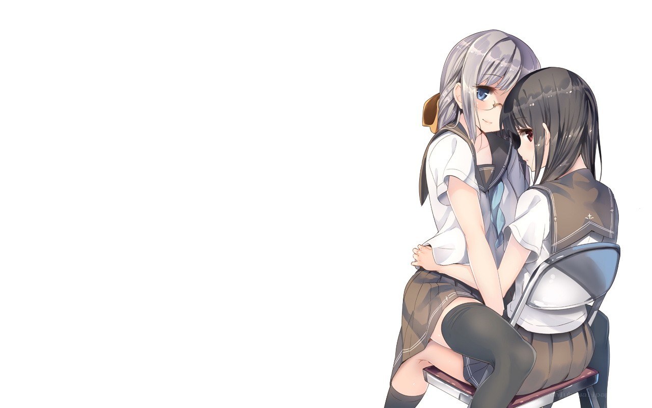 Two girls hugging on a chair