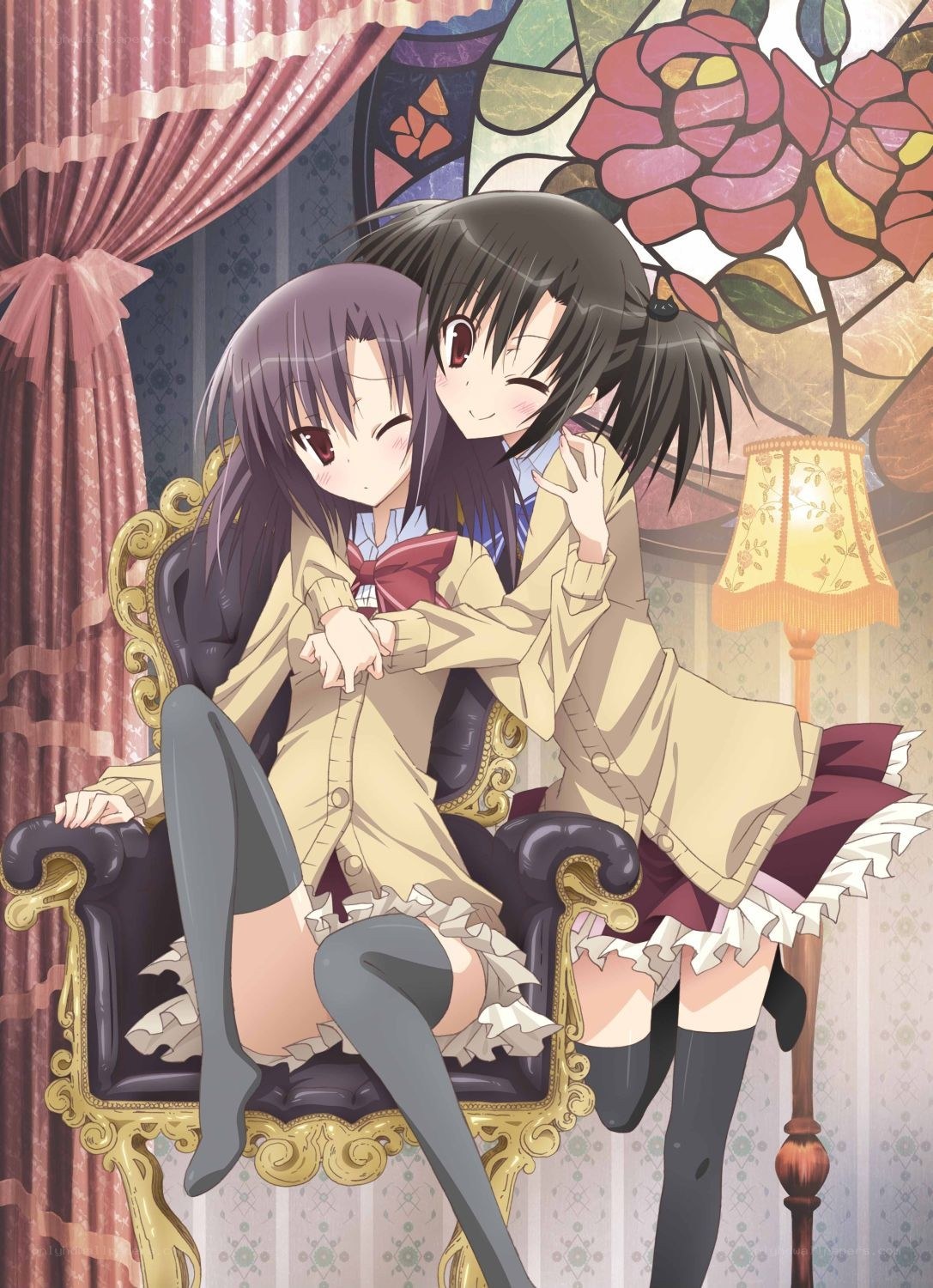Two girls hugging on a chair