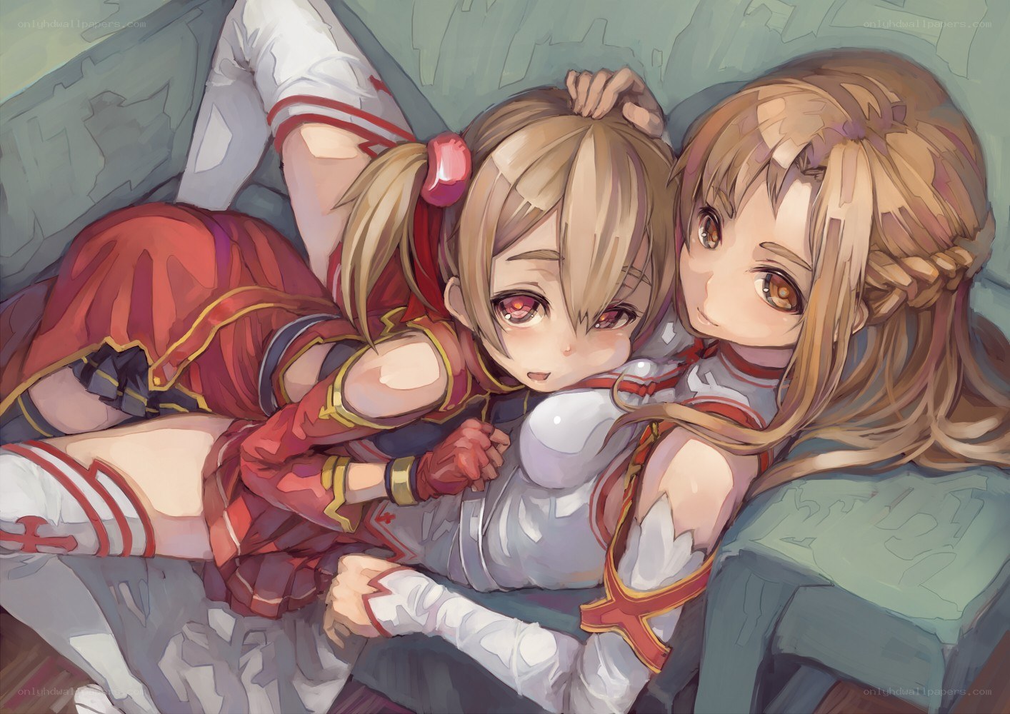 Two girls hugging on a couch