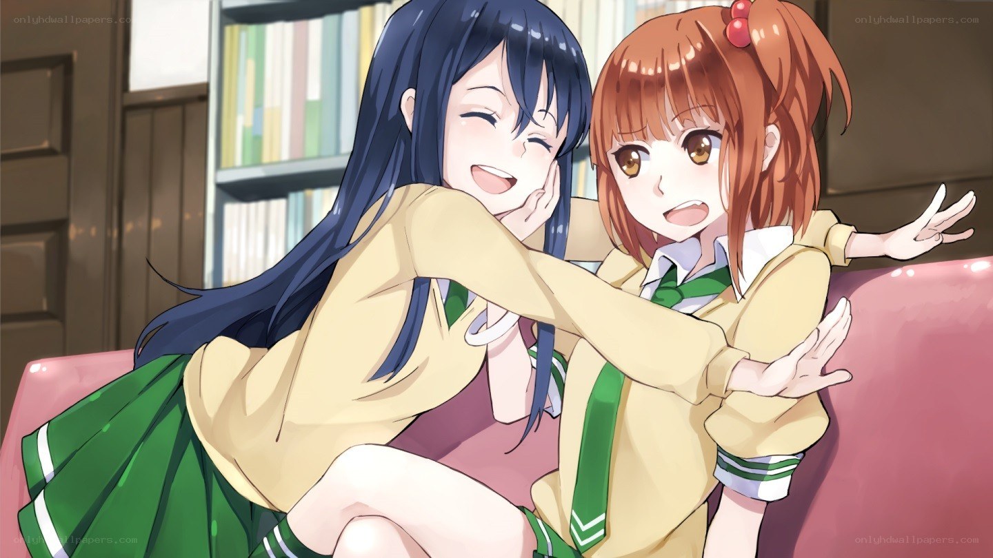 Two girls hugging on a couch