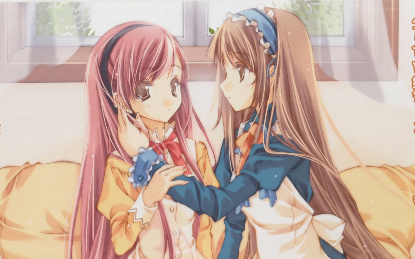 two girls hugging on a couch