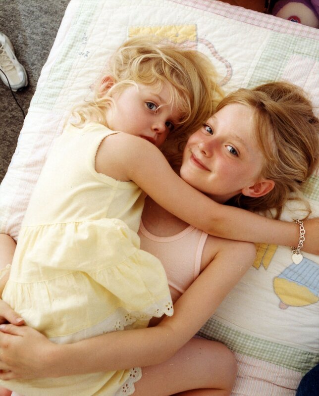 Two girls hugging on a quilt