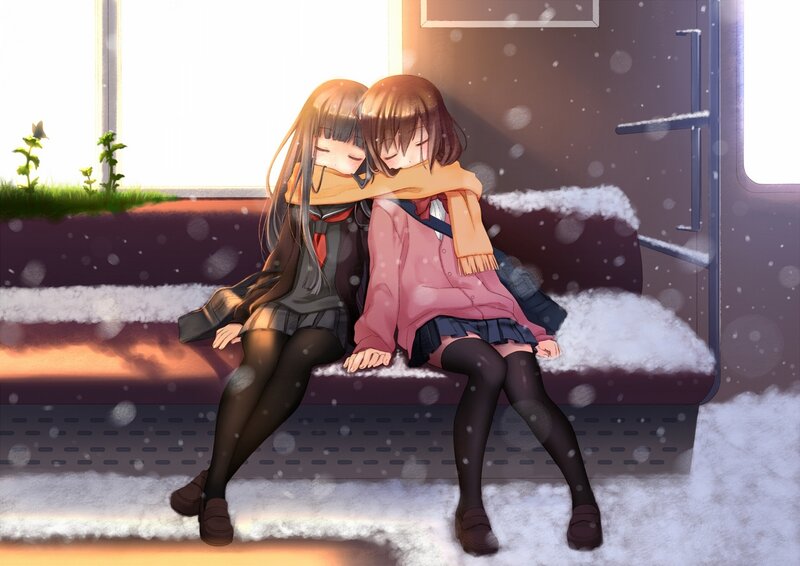 Two girls hugging on a snowy train