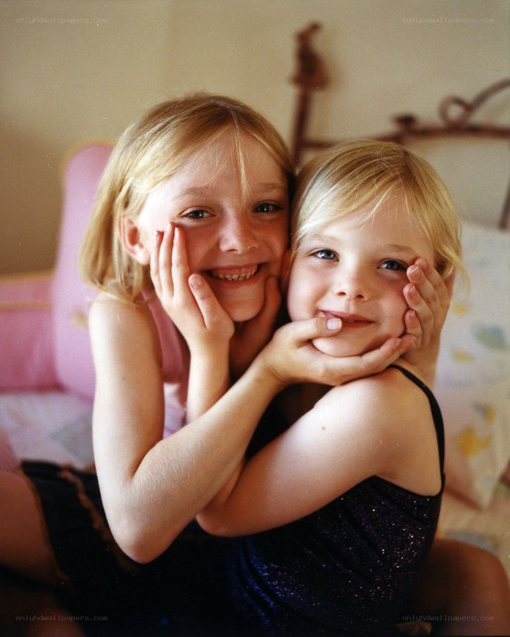 two girls hugging on bed