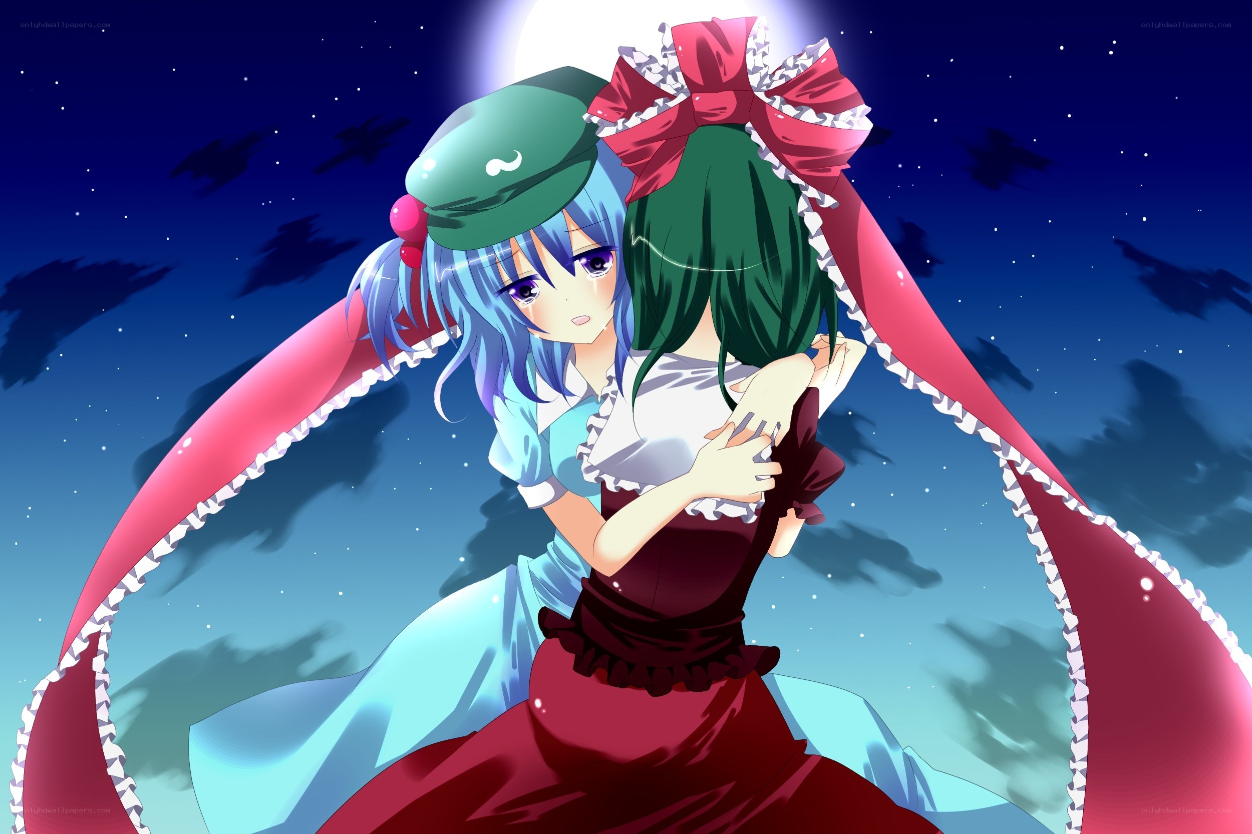 Two girls hugging under the moon