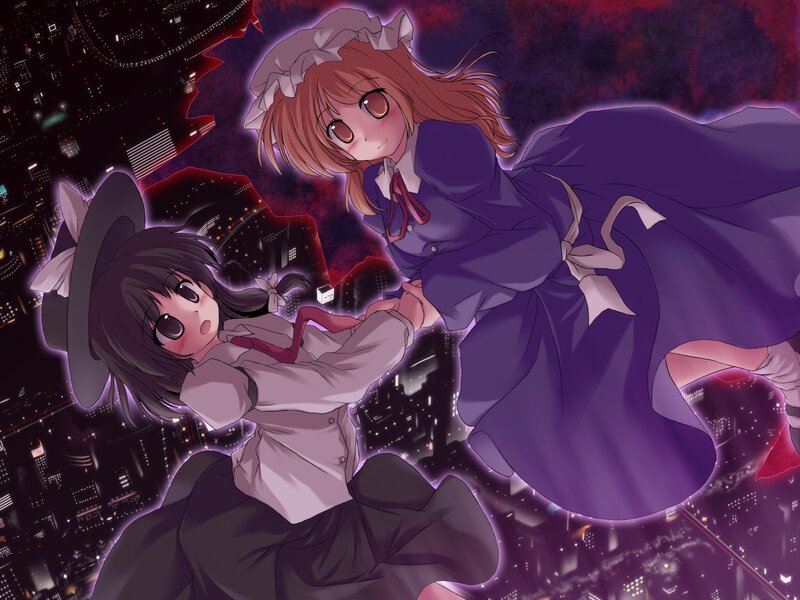 Two girls in a city at night