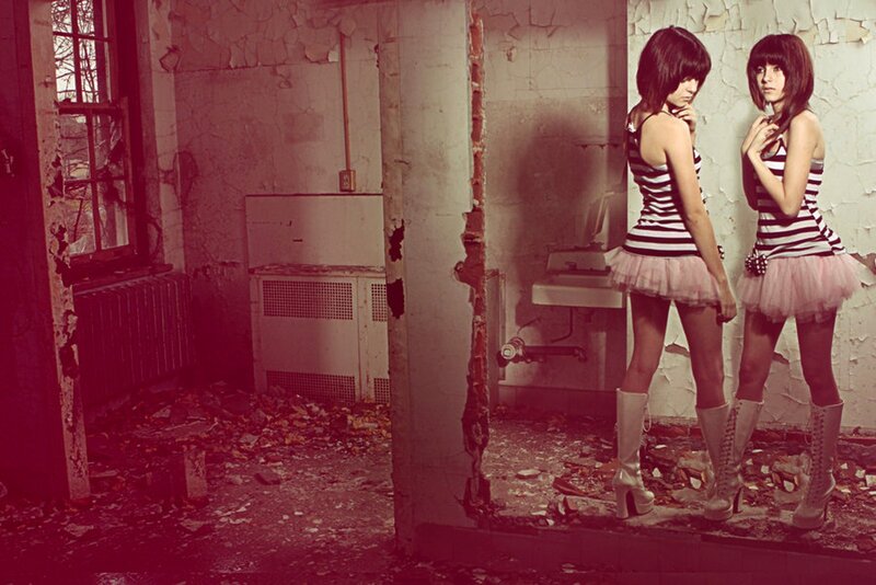Two girls in a derelict room