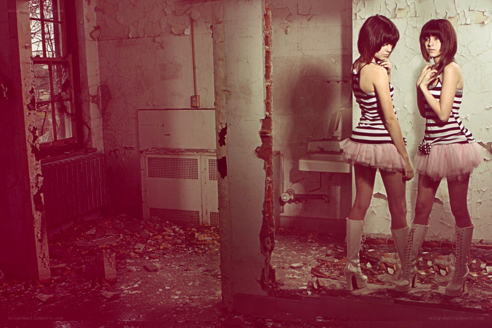 Two girls in a derelict room