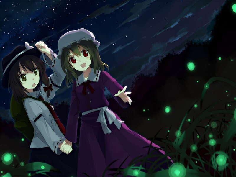 Two girls in a field at night