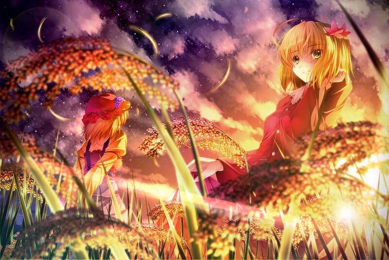 Two girls in a field at sunset