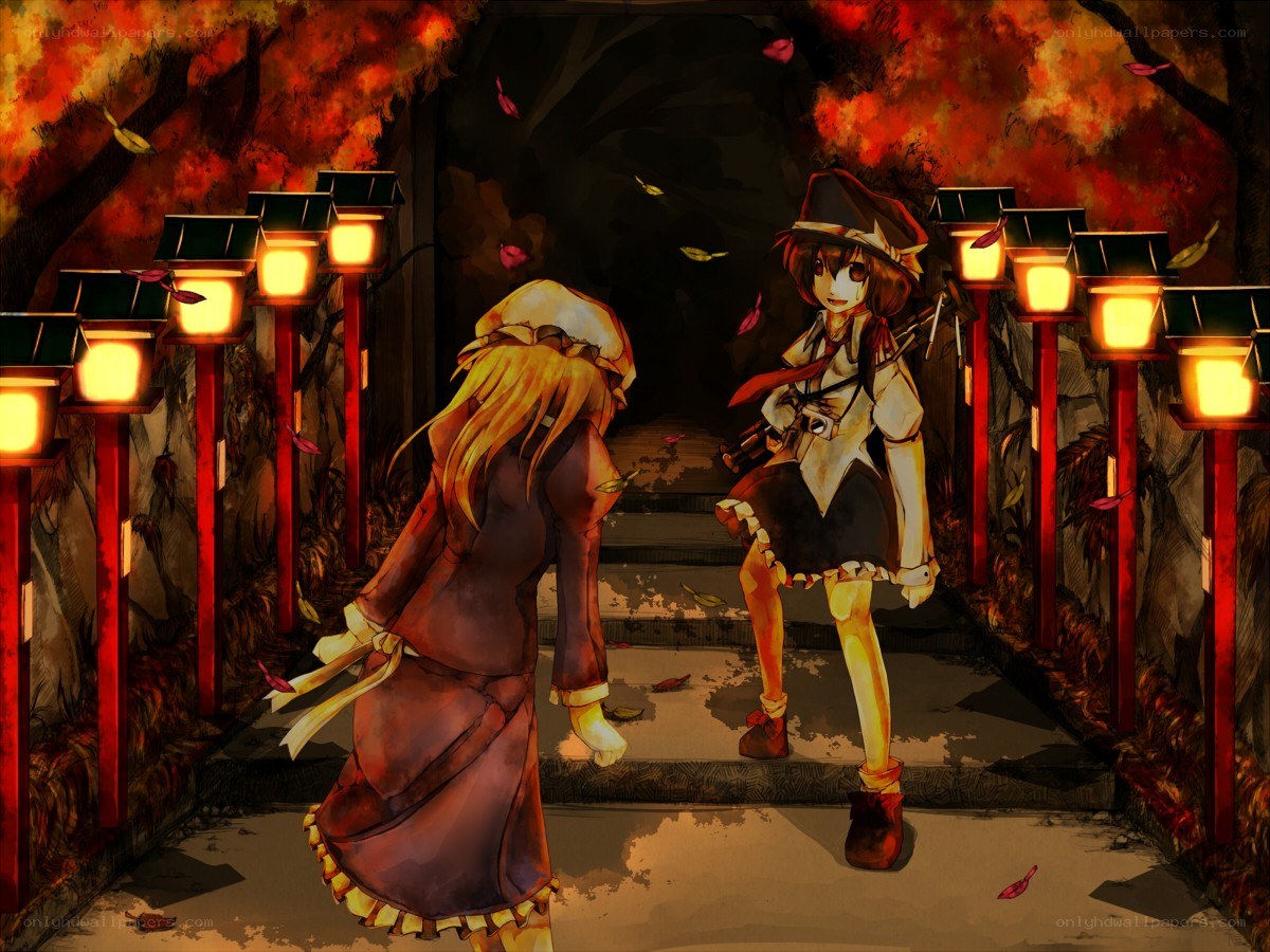 Two girls in a lantern-lit path